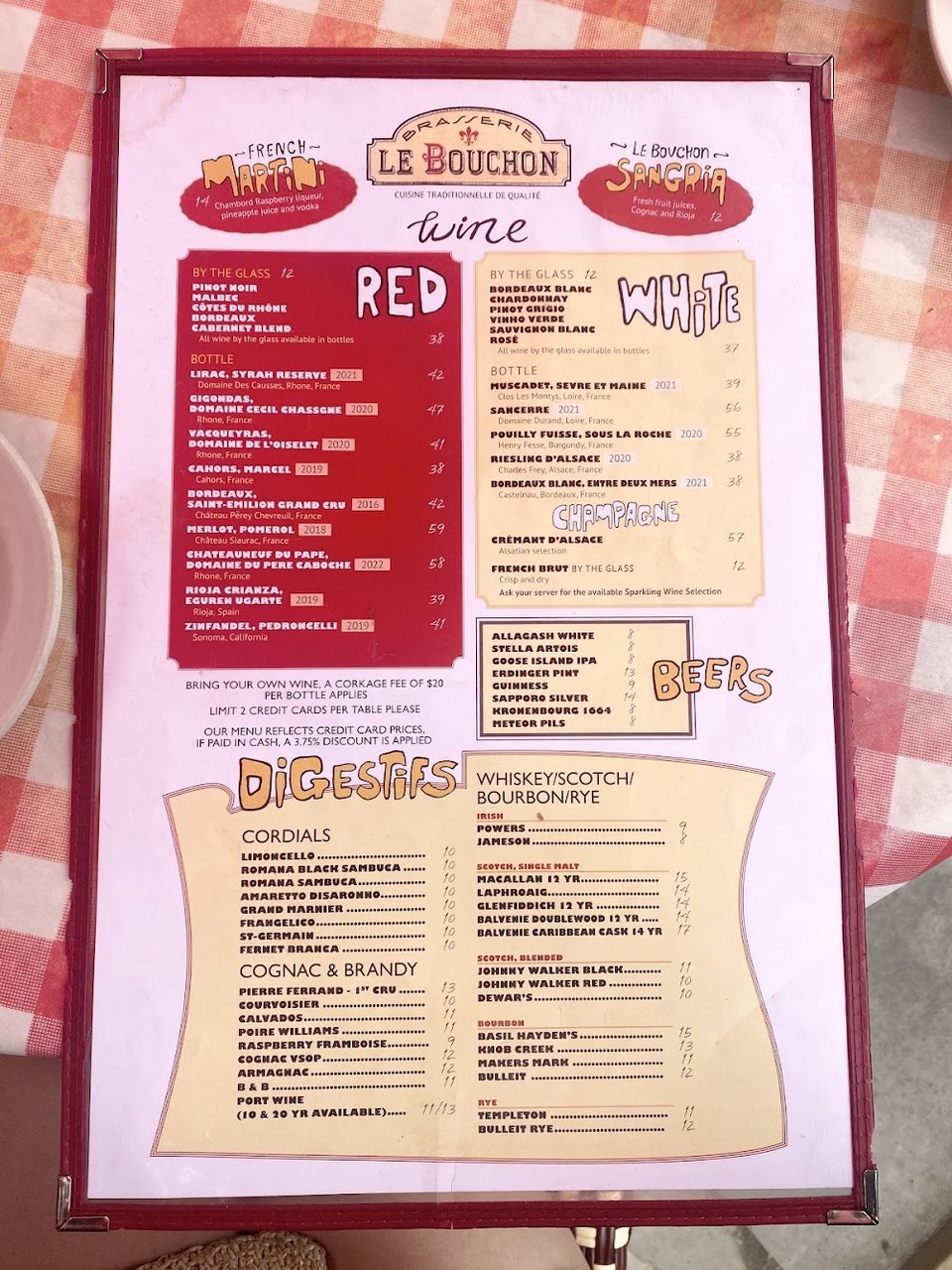 Printed menu with French classics and wine selections.